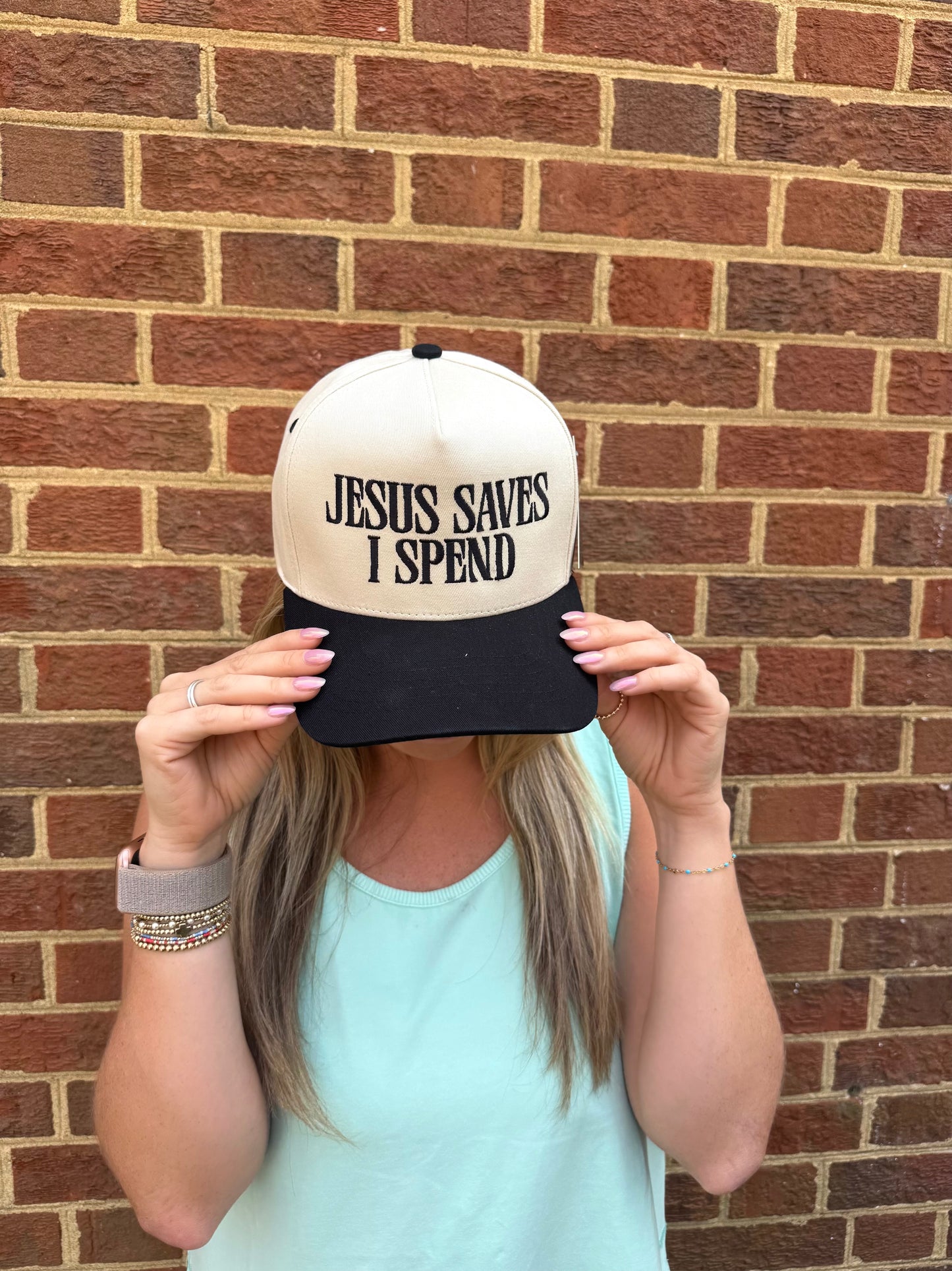 "Jesus Saves, I Spend" Trucker Hat in Black